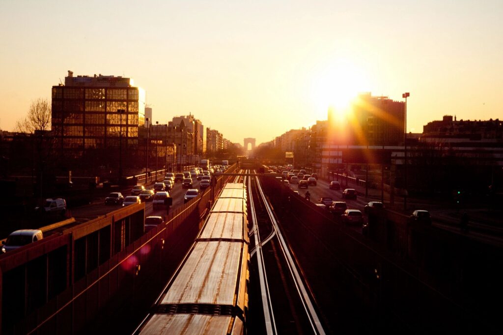Sunset over city train tracks and highway